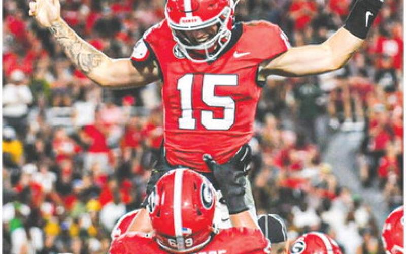 Georgia quarterback Carson Beck (15) celebrates with offensive lineman Tate Ratledge (69). Beck threw for a career-high 338 yards with three touchdowns against UAB. CHARLES JORDAN/Contributed