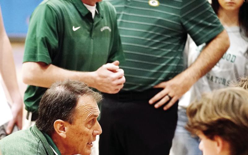 Gatewood head coach Don Keiser (left, crouching) attempts to rally his team in what turned out to be a disappointing 67-57 loss to Brentwood last Saturday at Tatnall Square Academy. BOB BETZEL/Contributed