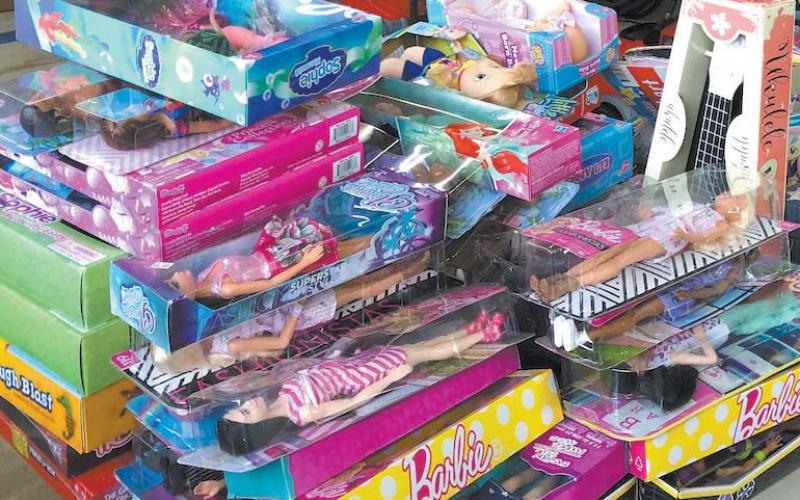 Barbie and other dolls are stacked ready for delivery in last year’s Fireman Santa project. Each year, the program helps Santa get toys to needy children for Christmas. FILE PHOTO