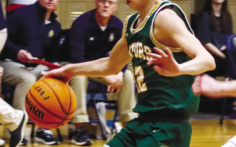Gatewood freshman Matt Allen (12) dribbles the ball inside the lane in transition against the Lions. LANCE McCURLEY/Staff