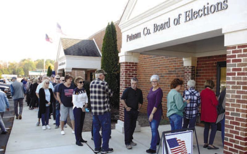 Spirits remained high among voters despite long lines Tuesday afternoon for early voting in the Georgia Senate runoff election. IAN TOCHER/Staff
