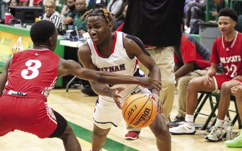 Putnam County senior Landon Bonner (2) tries to drive past a Laney defender. Bonner scored the team’s second-best 25 points in the loss to the Wildcats last week. LANCE McCURLEY/Staff