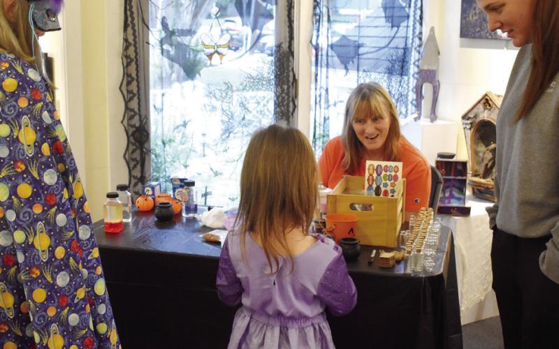 Participants dressed up at the Haunted Milledgeville reception and joined together in making potion souvenirs to take home. BAILEY BALLARD/Staff