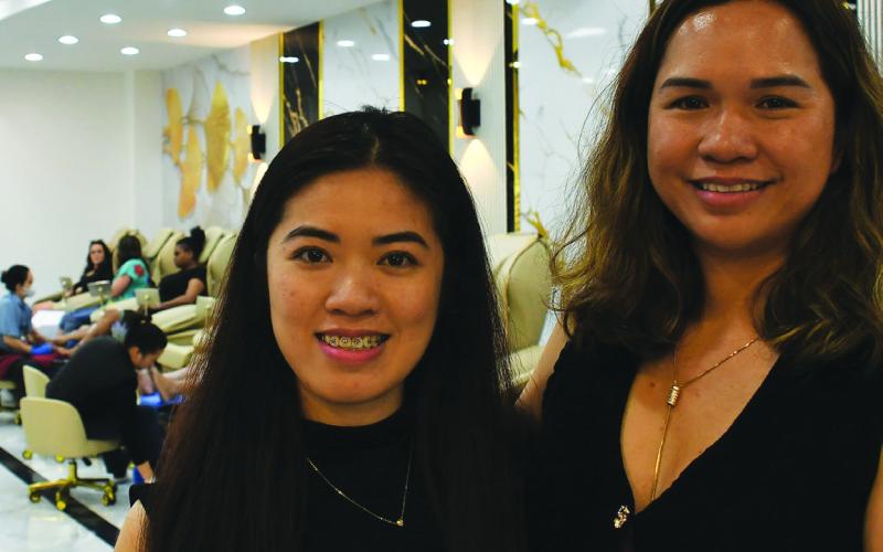 Business owner Jennifer Nguyen (right) runs Sassy Nails in Eatonton with help from her niece, Natalie Than. IAN TOCHER/Staff