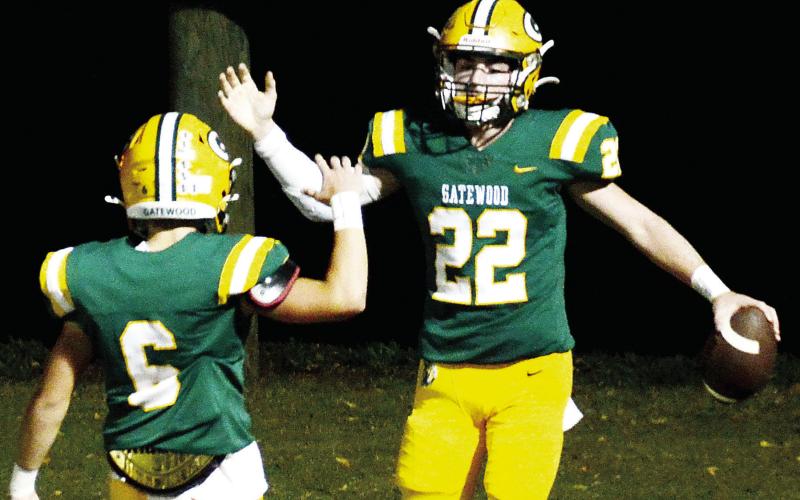 Gatewood senior Hunter Johnson (22) celebrates his second touchdown of the opening quarter Friday night with sophomore teammate Drew Love in what turned out to be a 48-6 win over the visiting Thomas Jefferson Jaguars. IAN TOCHER/Staff
