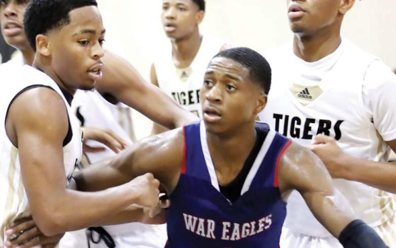 Triple coverage by Greene on Eagles senior Eren Banks (1). ARELLA CASH/Staff