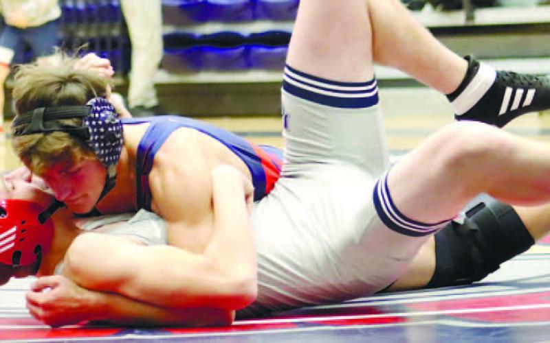 Mark Winslette wrestles his opponent to the ground for a pin. ARELLA CASH/Staff