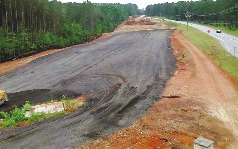 Georgia Dept. of Transportation contractor workers are making preparations to complete the US Hwy. 441 widening project in Putnam County. MARK ENGEL/Staff