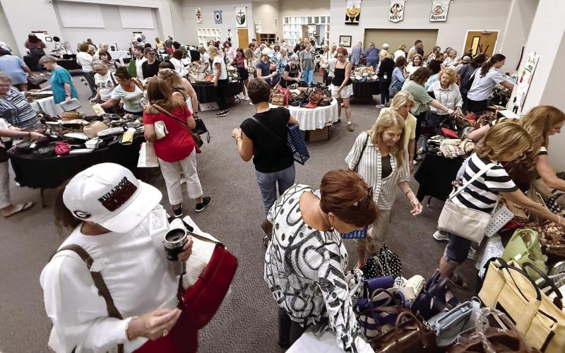 Women dominated the crowd at Upscale Resale, where donated, gently used, high-end pieces of jewelry, purses and carryalls, some clothing, and even a collection of fine jewelry was available for purchase to support local food pantries. IAN TOCHER/Staff