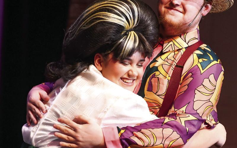 Kellsey Ortega, who played Tracy Turnblad, the primary character in “Hairspray,” shares a moment with actor Tom Crowell, who played her father in the musical play. IAN TOCHER/Staff