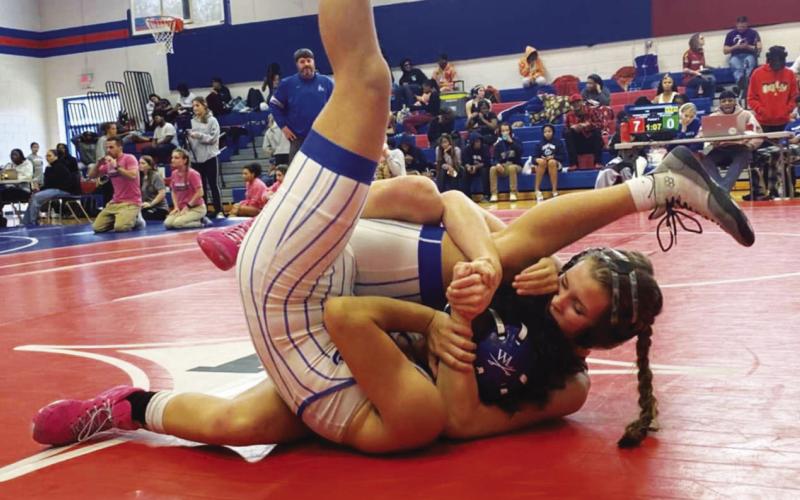 Putnam County’s Lily Armistead tries to pin her opponent during a match earlier this season. CONTRIBUTED
