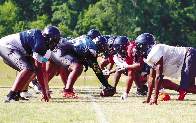 Putnam County’s first-team offensive and defensive lines get set for a live-action rep at Monday’s spring practice. LANCE McCURLEY/Staff