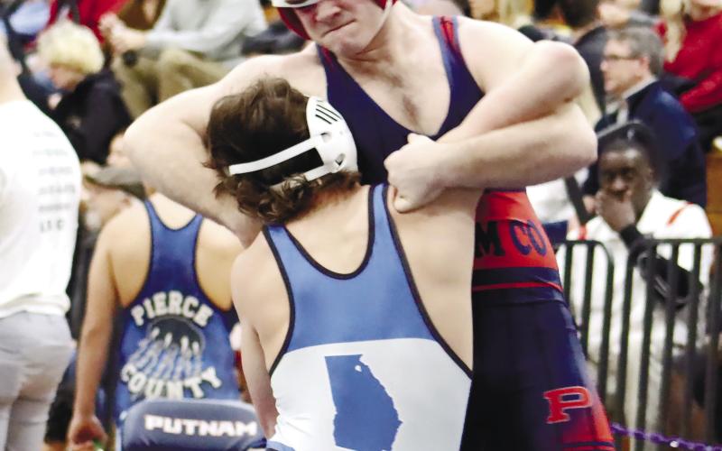Tristian Lower tries to wrestle an opponent to the ground.