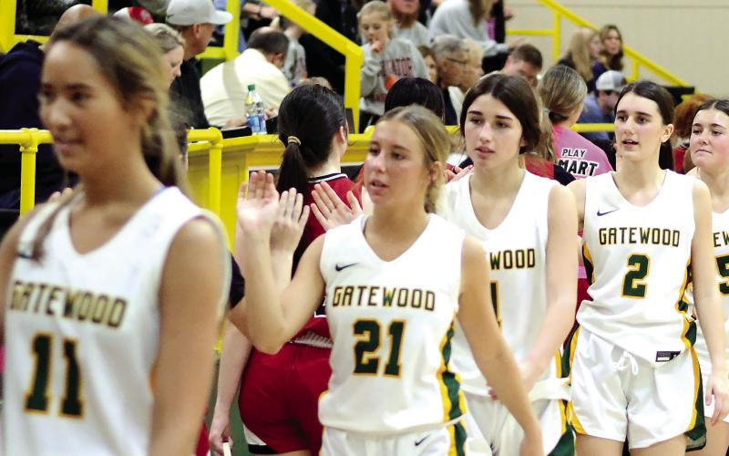 The Lady Gators high-five after a game last week. TREY NORRIS/Staff