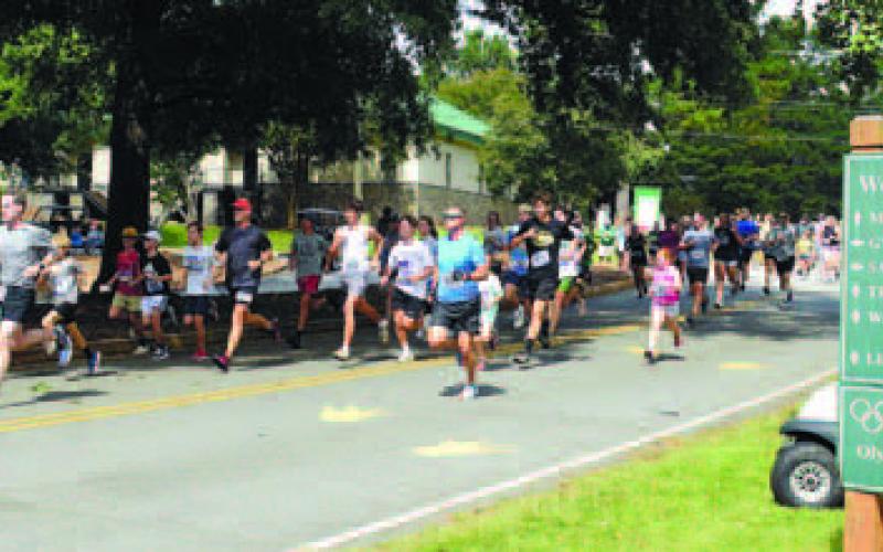 And they’re off: Florida’s George Kirk leads the field away from the start of this year’s Swamp Stomp and wound up second overall and first in the Masters division.p Stomp 5K. IAN TOCHER/Staff