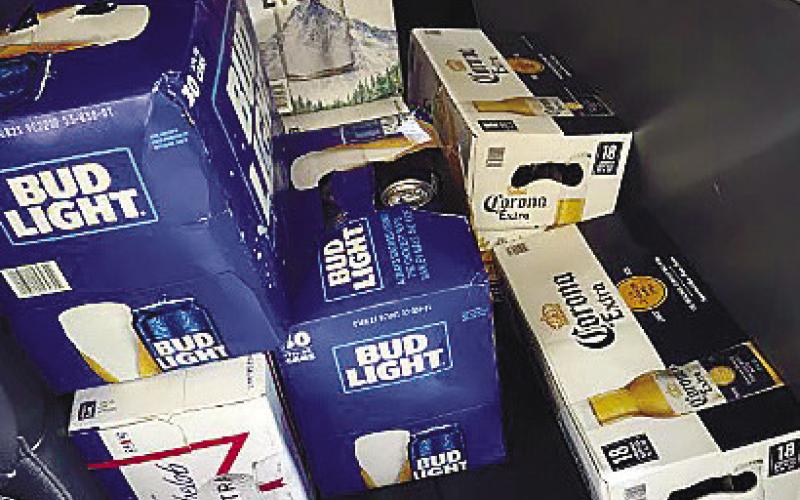Cases of stolen beer are stacked in the back seat of the Camry involved in a police pursuit. The brews were returned safely to the grocery store. CONTRIBUTED