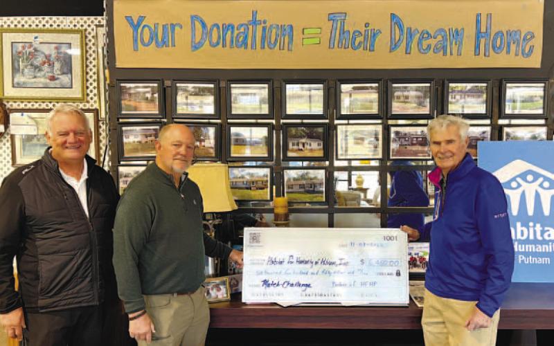 Chaplain Doug Turner (left) and Mike Rowland from Grove Chapel Ministries recently presented a $6,450 check to Putnam County Habitat for Humanity Board Chair Bucky Kahl (right), for the construction of two new roofs on current house builds on South Madison Avenue in Eatonton. This cumulative gift from community members at Grove Chapel helps lower the cost of construction for the affiliate, which translates to greater impact in the Putnam County community. CONTRIBUTED