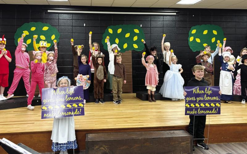 Dressed as Lemonade storybook characters, young Gatewood actors hold up lemons while others display signs reminding everyone: “When life gives you lemons, make lemonade!” EMME CLAUSE/Staff