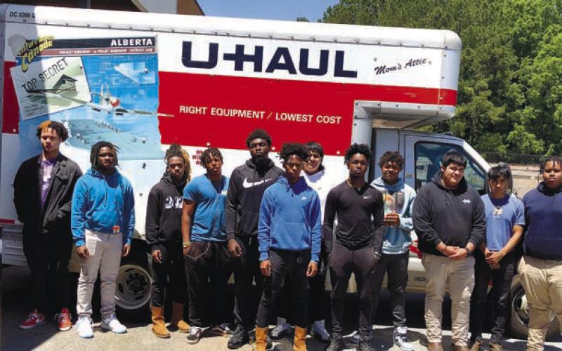 CONTRIBUTED Members of GCHS TIGERS Football Team help unload computers.