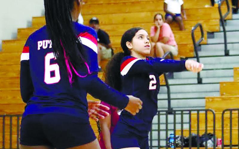 Priscilla Sepulveda (2) sets up her teammate for a spike.