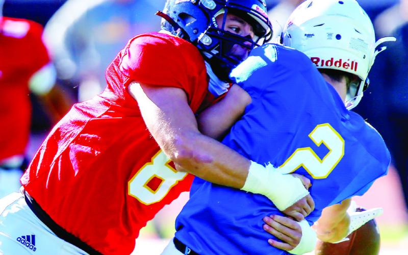 Linebacker Branan Griffin (8) brings down Oconee County quarterback Brody Hannah (2). LANCE MCCURLEY/Staff