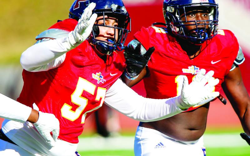 Defensive lineman Steven Grandt (57) and Christian Farley (14) rush the passer. LANCE MCCURLEY/Staff