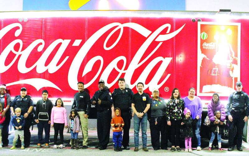 All of the Shop with a Cop participants gather in front of Walmart before their shopping sprees. LYNN HOBBS/Staff