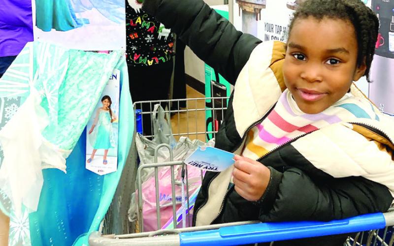 Athena Hall, 5, shows off the Elsa dress she purchased through Shop with a Cop. “I’m gonna be so pretty,” she beamed. LYNN HOBBS/Staff