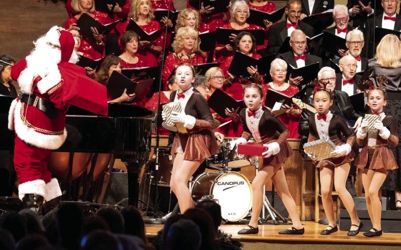 The Arts Barn Kids were Jordan Loh, Annie Manning, Alice Manning, and Ellie Swymer onstage with Santa Aaron Crowell. LEIGH LOFGREN/Staff