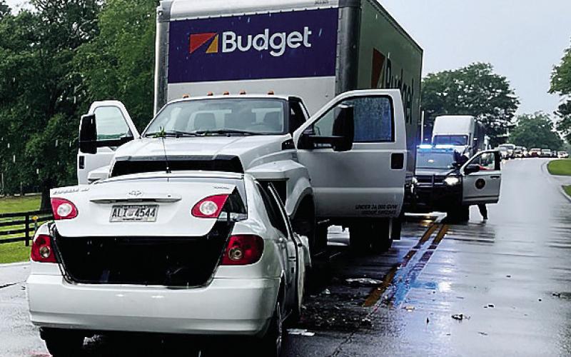 The driver of this Toyota Corolla was killed when the car crashed straighton into the Budget Rental box truck Friday afternoon on the Sparta Highway. CONTRIBUTED/PCSO