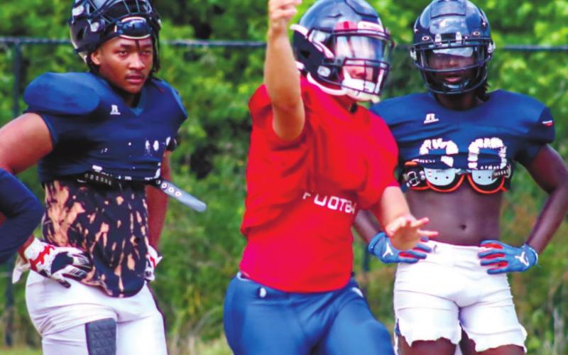 A War Eagles quarterback (center) fires a ball to an open receiver in the flat. LANCE MCCURLEY/Staff