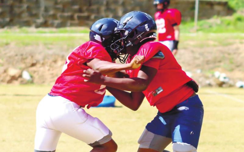 Two Putnam County players make hard contact during a blocking drill. LANCE MCCURLEY/ S t a ff