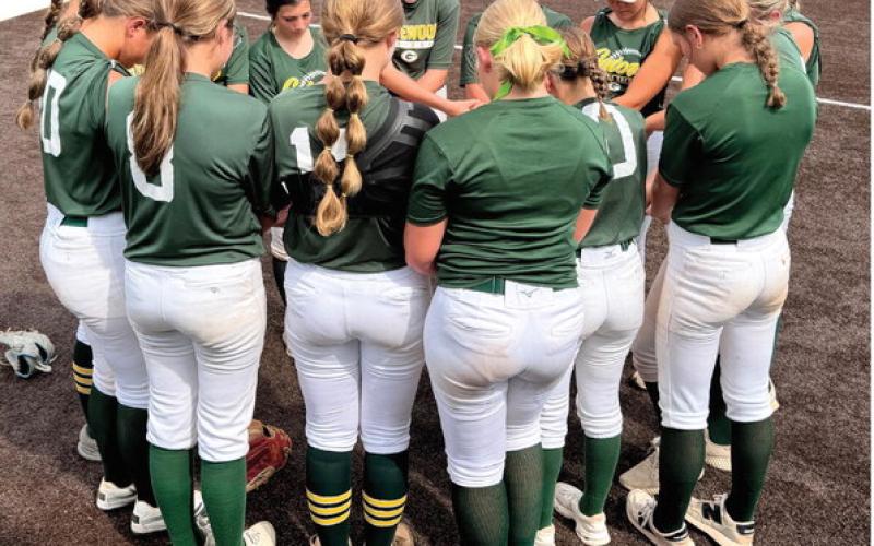 The Gatewood softball team gathers for a prayer before a scrimmage earlier this summer. CONTRIBUTED