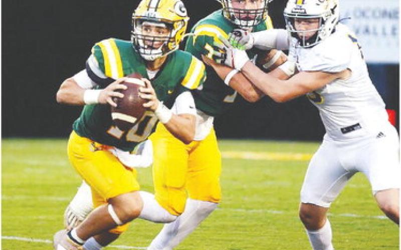 Gatewood quarterback Ames Johnson (10) and UNC commit Evan Bennett (7) both look upfield for any offensive opportunity available. IAN TOCHER/Staff