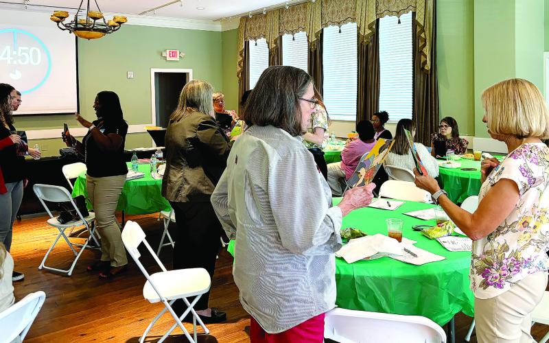 Attendees participate in the group activity, working together to put their pictures in the correct order. (EMME CLAUSE/Staff)