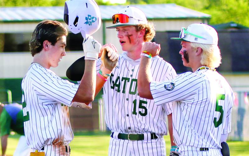 Gatewood’s Ben Brannen (2), Lawson Wooten (15), and Caleb Riser (5) celebrate after winning game one last Friday against the Warriors. TREY NORRIS/Staff
