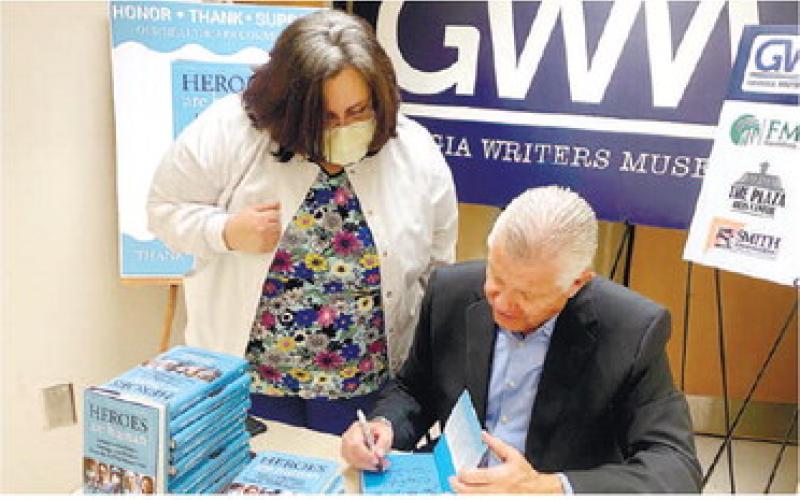 Emergency Room Director April Collins has her book signed by Delaney during his visit to Putnam General Hospital. CONTRIBUTED
