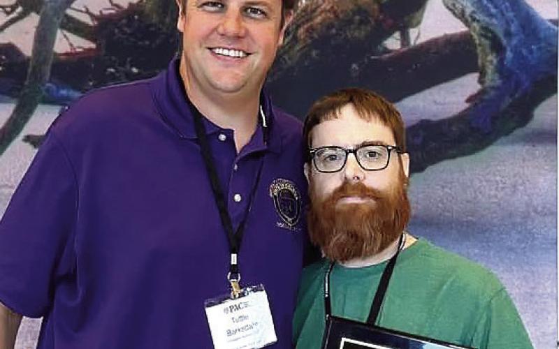 Investigator Clay Wiggins (right) and Ocmulgee Circuit District Attorney Wright Barksdale after the award was announced. CONTRIBUTED