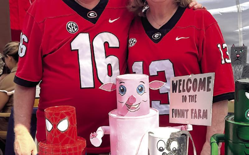 Allan and Julie Dodson show off their art sold at “Dad’s Woodshed.” They were one of 80 registered artisans at the market. ALIVIA BLANTON/ Staff