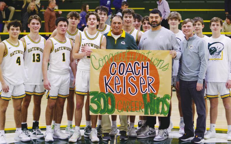 Gatewood head coach Don Keiser (green shirt) enjoyed a moment with his players, including his son, Kaden (13), after they delivered his 300th career win with a 72-53 finish over the visiting Trinity Christian Crusaders. IAN TOCHER/Staff