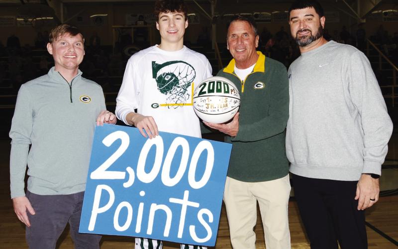 Before the start of Friday night’s game against Trinity Christian in Eatonton, (l-r) Gatewood assistant Christian Keiser, junior Matt Allen, head coach Don Keiser, and assistant coach Doug Price celebrated the 2,000-point milestone passed by Allen the previous week, also against Trinity in Dublin. IAN TOCHER/Staff