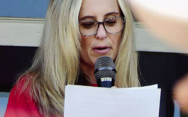 County Commission District 4 candidate Jennifer Ray reads a prepared statement Sunday afternoon in downtown Eatonton. IAN TOCHER/Staff