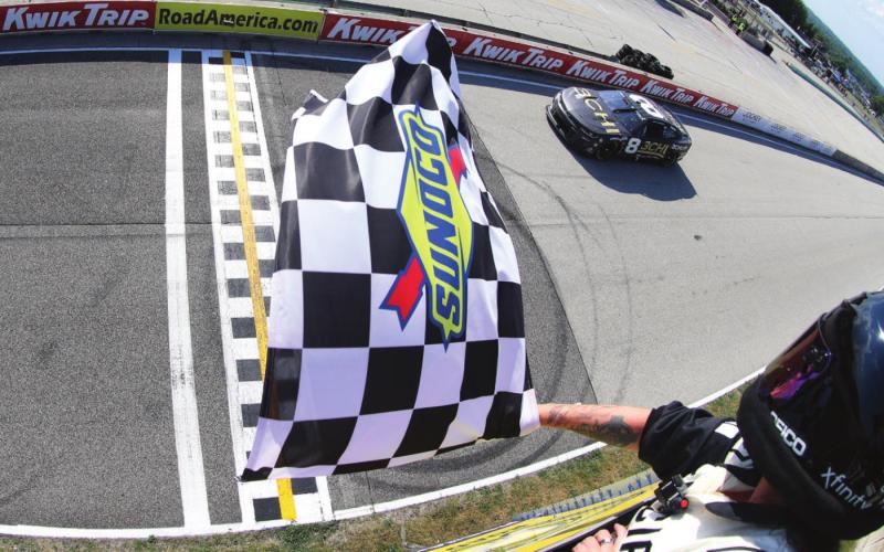 Tyler Reddick, driver of the #8 3CHI Chevrolet, takes the checkered flag to win the Cup Series Kwik Trip 250 at Road America Sunday. (Sean Gardner/Getty Images)