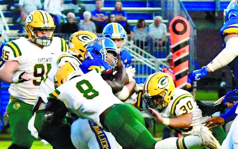 Gators defenders Blake Daniel (95), Demarion Maddox (8) and Dakota Davis (30) combine to make the stop on a Cavaliers ball carrier. DAWN SINCLAIR/Contributed