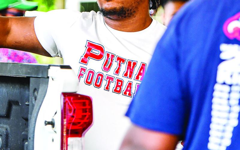 Putnam County assistant football Tre’Von Ellison socializes with participants during the event. (CHARLES JORDAN/Staff)