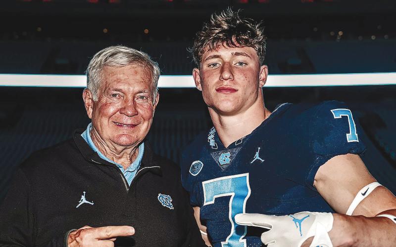 UNC head coach Mack Brown (left) poses for a photo with Gatewood’s Evan Bennett (right) at Kenan Memorial Stadium over the weekend. CONTRIBUTED