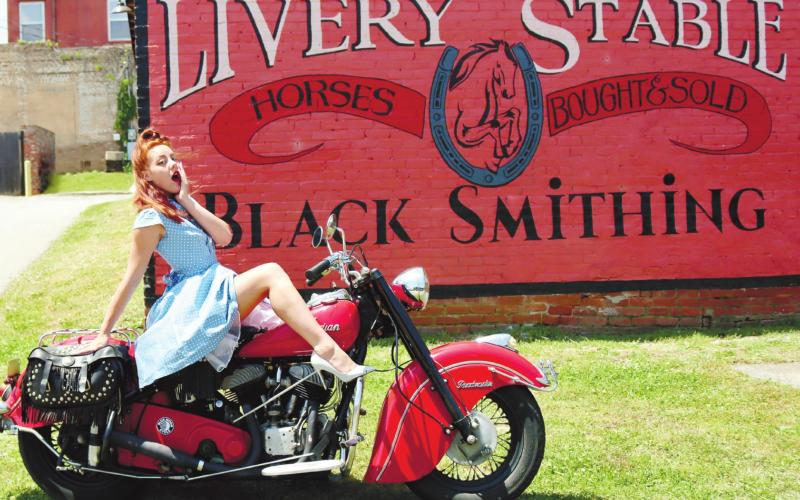 A member of Lifers Car Club poses with her motorcycle. ARELLA CASH/Staff