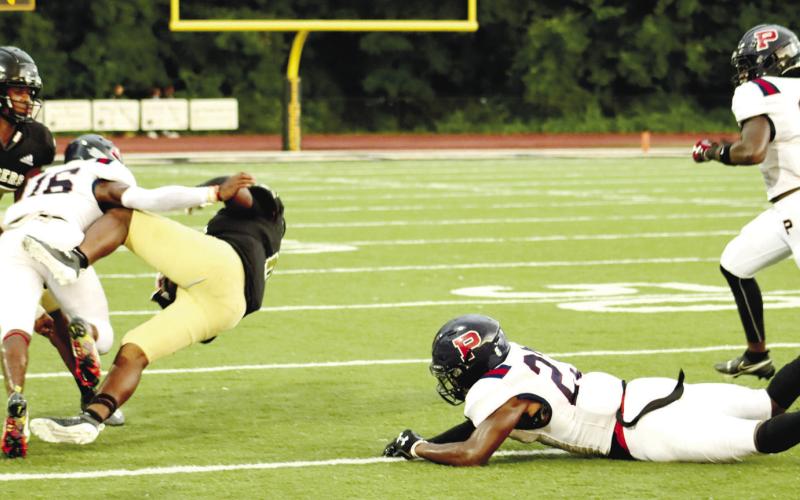 Brayon Farley with a hit near blockers Jalon Kilgore (23) and Tyson Waller (11).