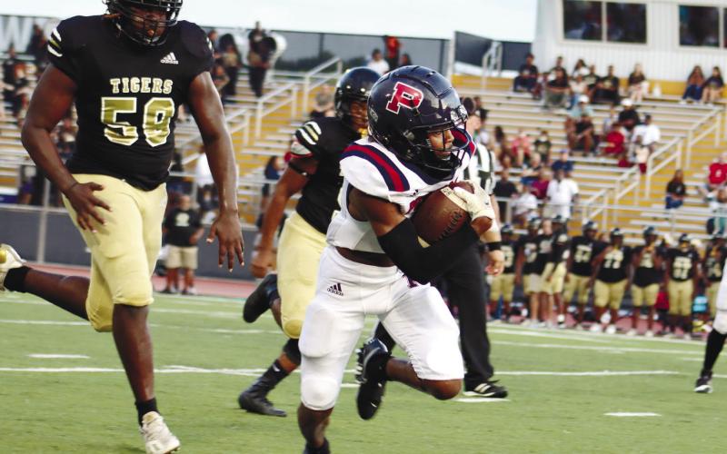 Senior DJ Bland runs the ball down_eld for the Putnam team.