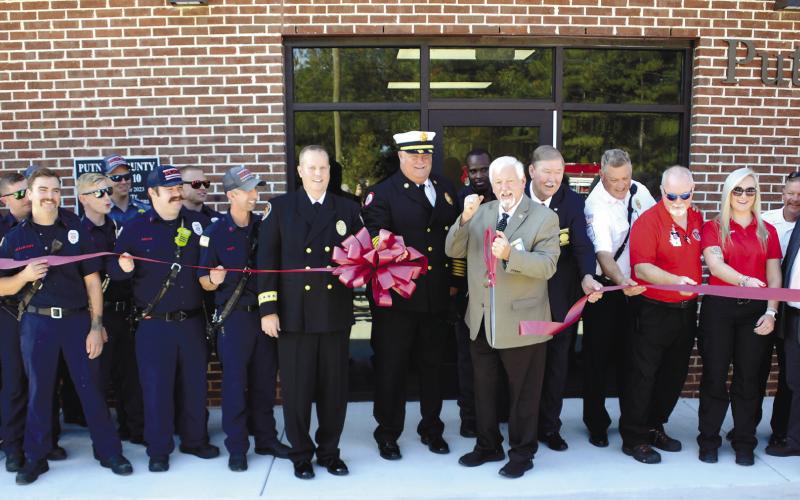 With Putnam County Fire Chief Tom McClain by his side, County Commission Chairman Bill Sharp enthusiastically cut the ceremonial ribbon to officially open the county’s new fire/EMS/coroner facility north of Eatonton, alongside the bypass. IAN TOCHER/Staff